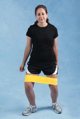 Hình 14 Bước đi với dây đàn hồi về phía trước chống lại lực cản đàn hồi vòng quanh đùi để làm mạnh các cơ xoay ngoài đùi chuỗi động đóng.